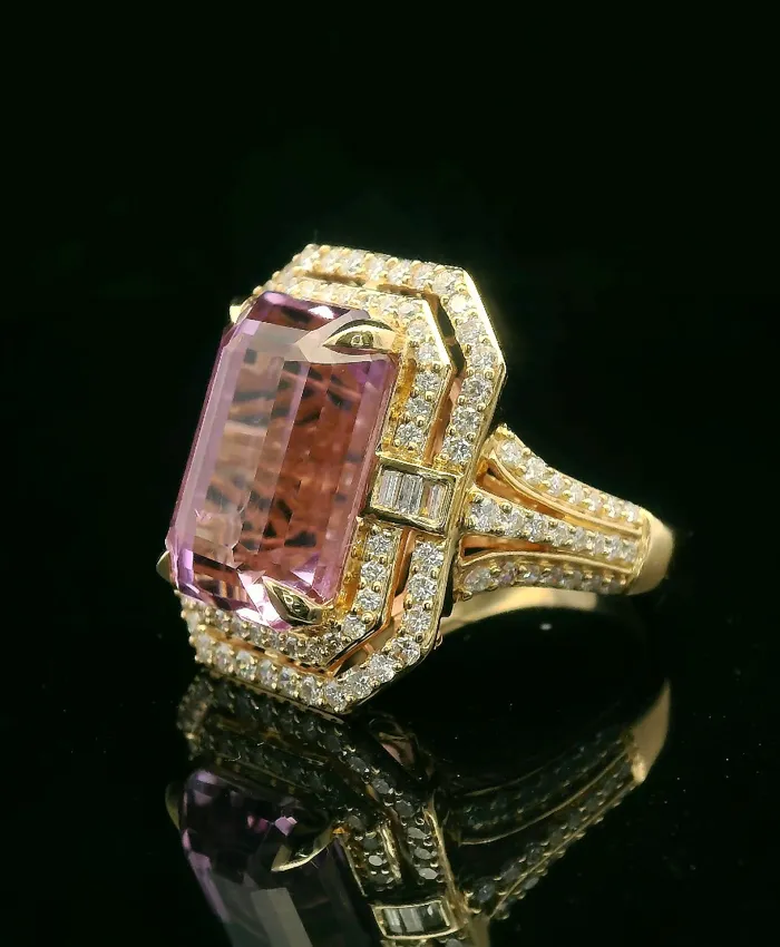 Elegant gold ring featuring a large pink gemstone surrounded by sparkling diamonds, perfect for special occasions.