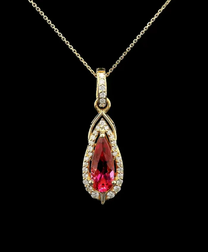 Elegant gold pendant featuring a pear-shaped pink gemstone surrounded by sparkling diamonds.
