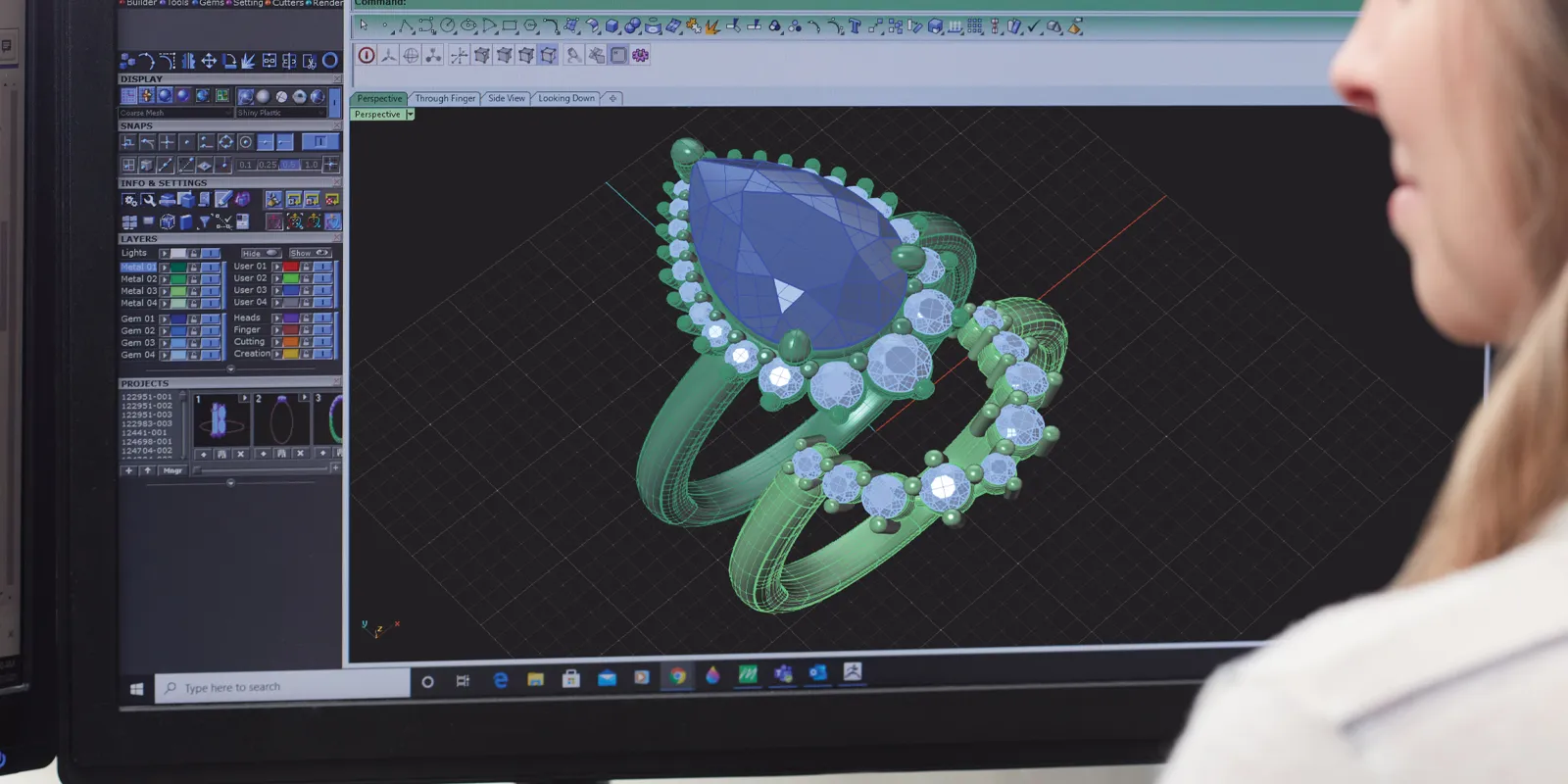 3D rendering of a custom jewelry ring design on a computer screen, showcasing a blue gemstone and intricate details.