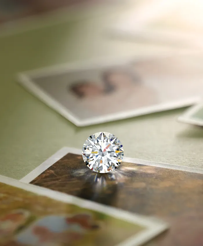 A sparkling diamond rests on vintage photographs, symbolizing love and memories.