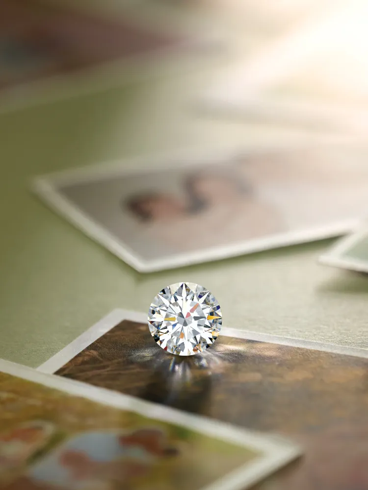 A sparkling diamond rests on vintage photographs, symbolizing love and memories.