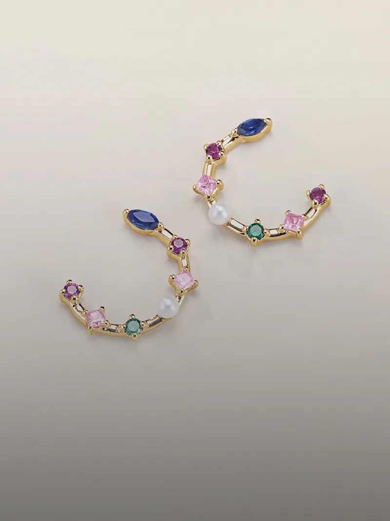 Colorful gemstone earrings with gold accents, featuring various shapes and a pearl.
