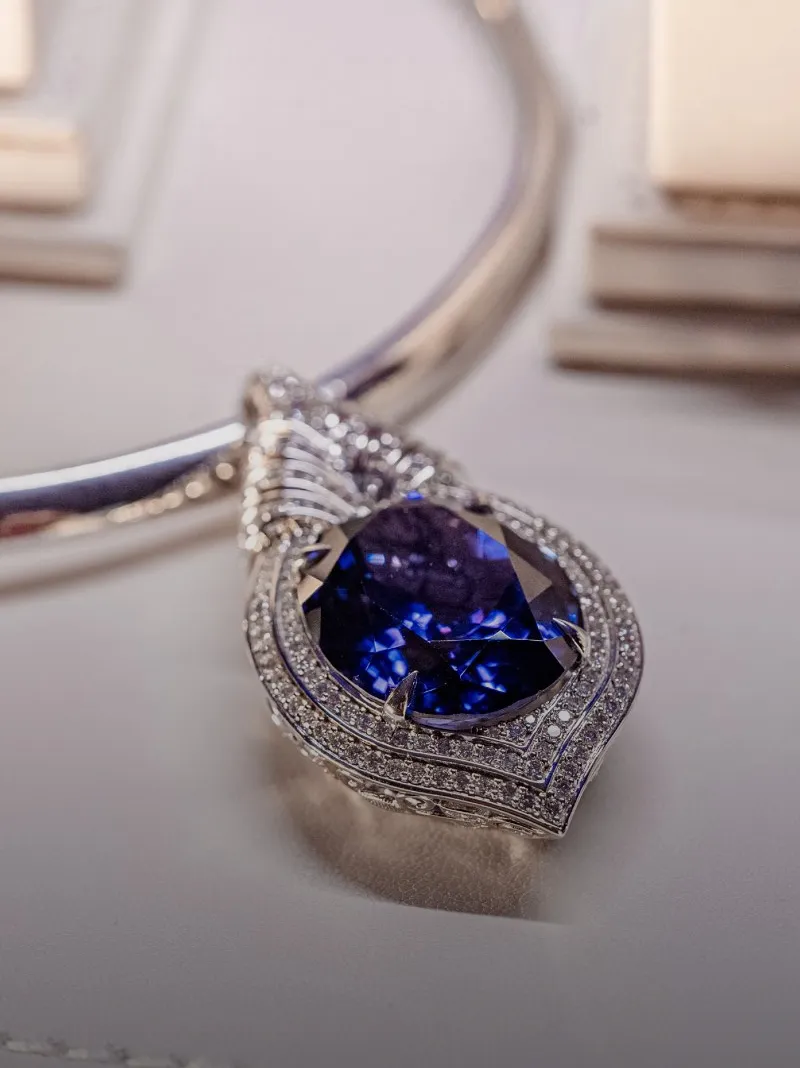 Elegant tanzanite pendant necklace with diamond accents.