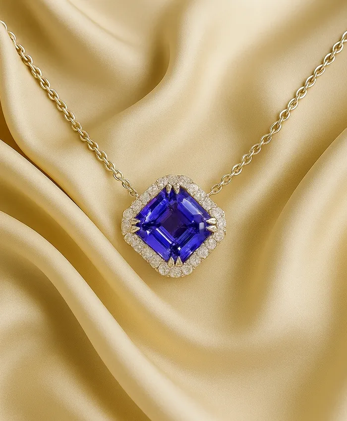 Elegant gold necklace featuring a large purple gemstone surrounded by diamonds, set against a soft golden fabric backdrop.