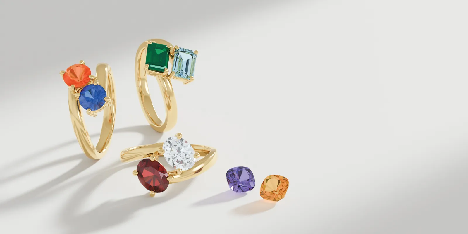 Colorful gemstone rings in gold settings, showcasing various styles and stones.