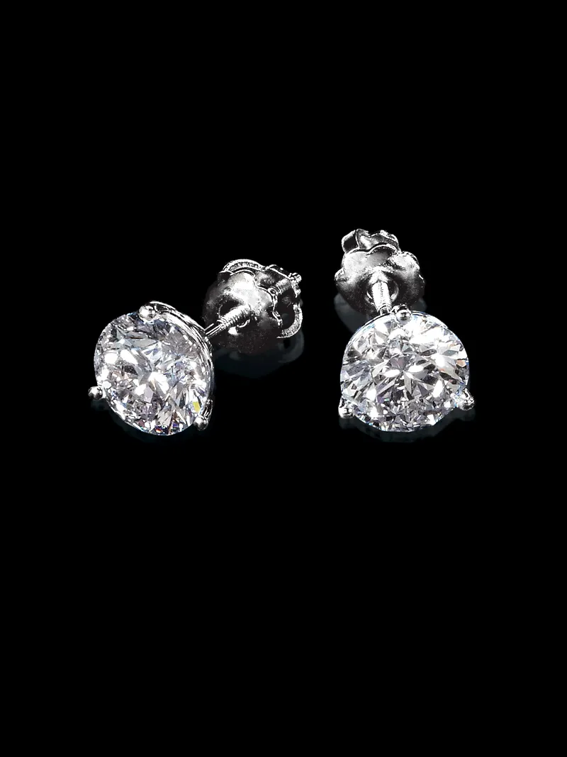 Elegant diamond stud earrings on a black background.