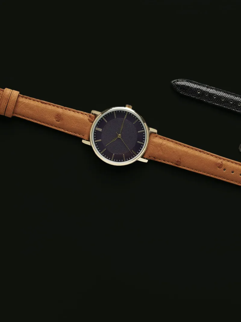 Stylish watch with a brown leather strap and a dark face, perfect for any occasion.