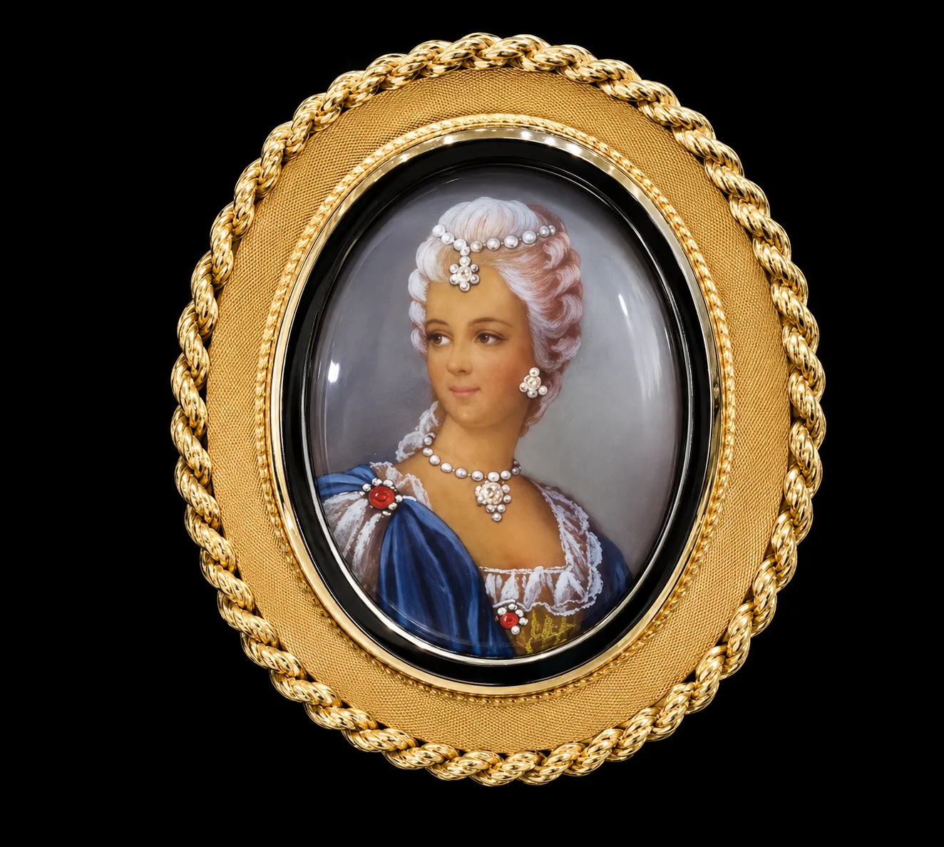 Vintage oval portrait miniature cameo brooch in ornate yellow gold frame with hand-painted lady on black background.