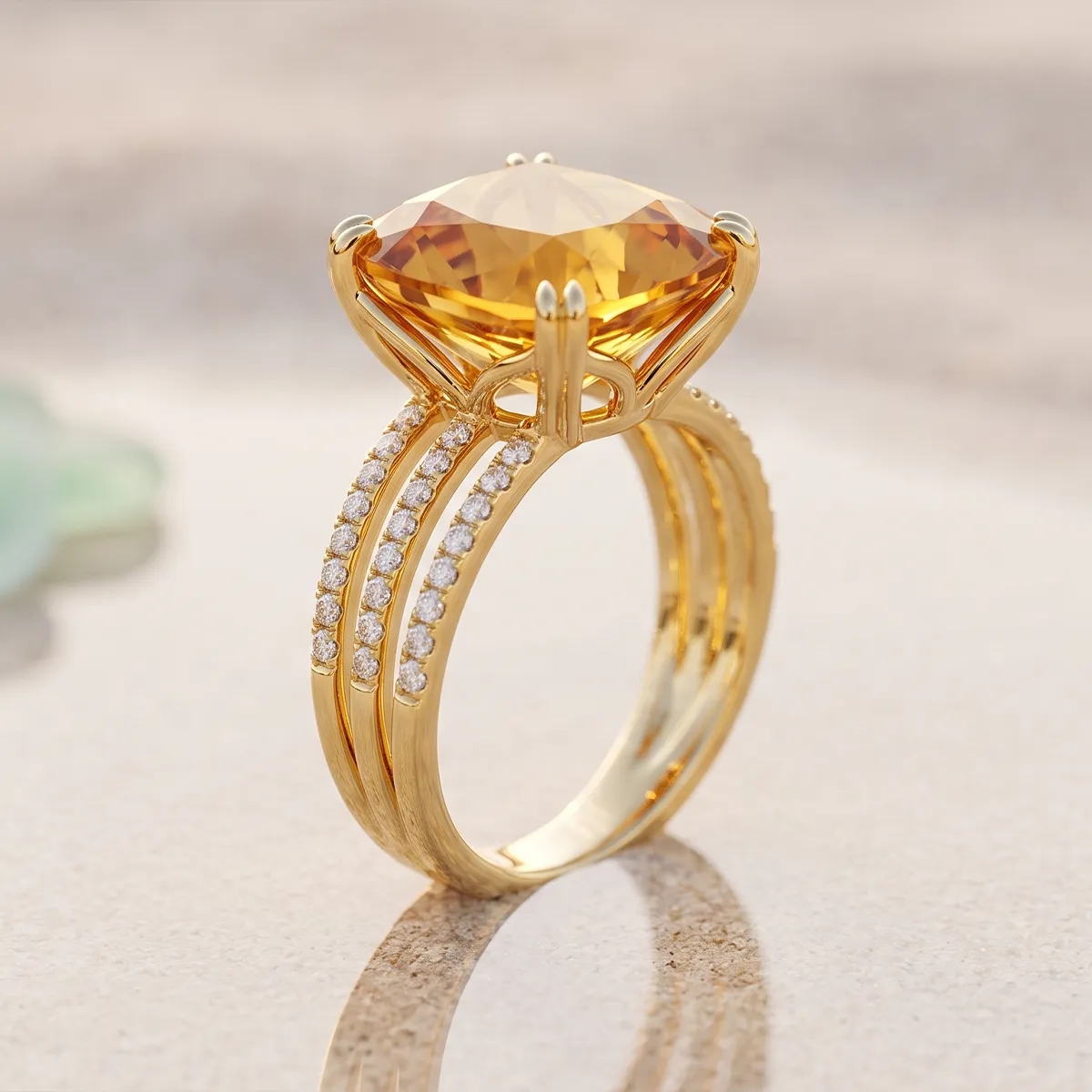 A gold ring with a large citrine gemstone and diamond accents on a reflective surface.