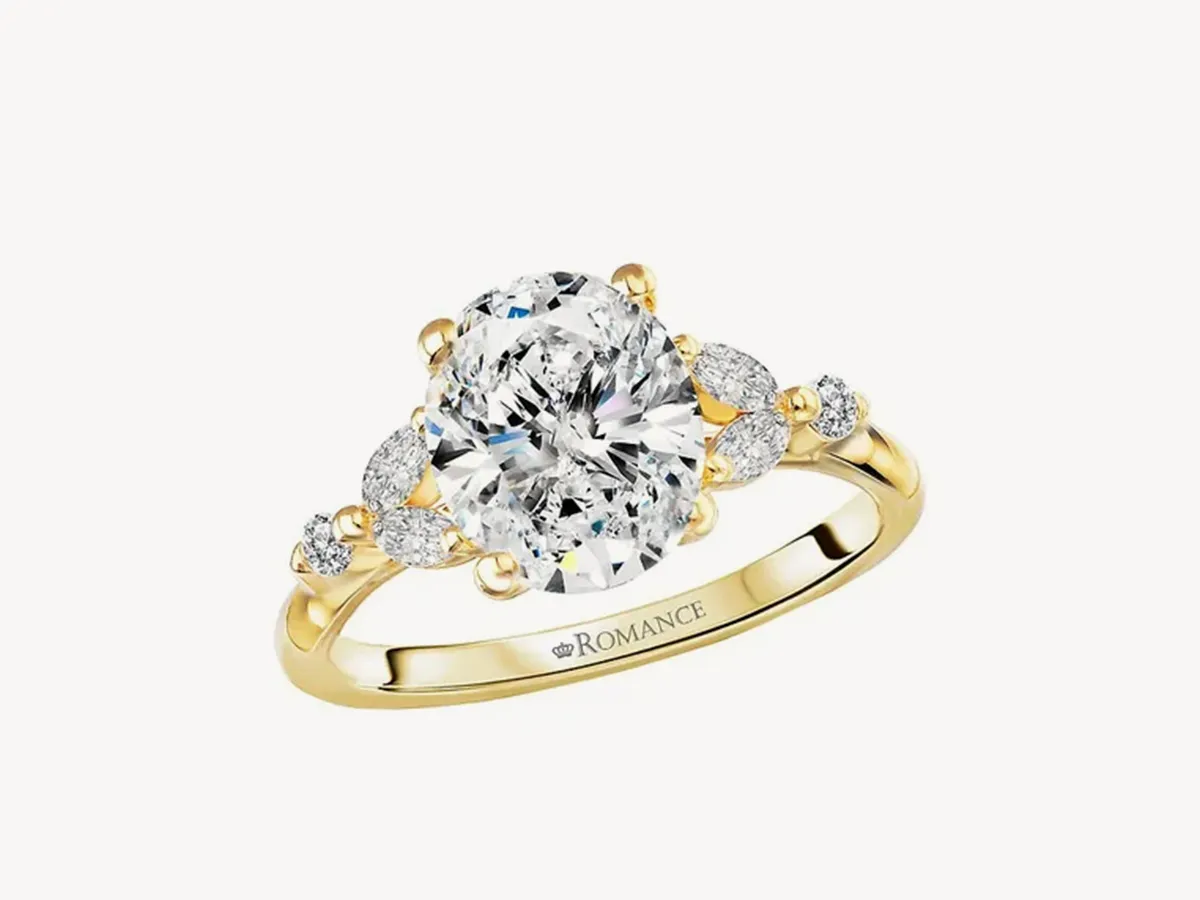 Gold ring with a large central diamond and smaller side diamonds. Click to explore customizable rings.
