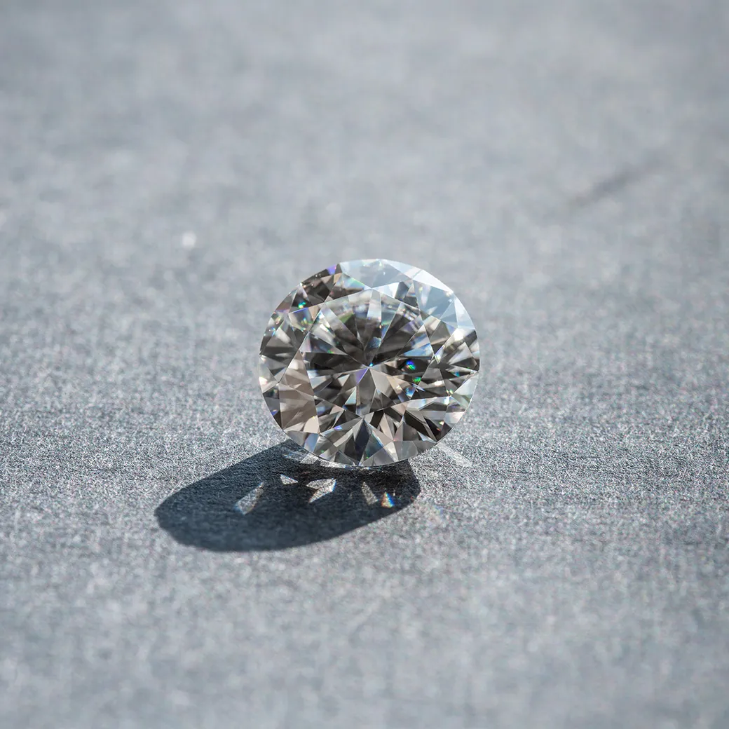 Elegant diamond ring with multiple rows of round stones on a reflective surface.