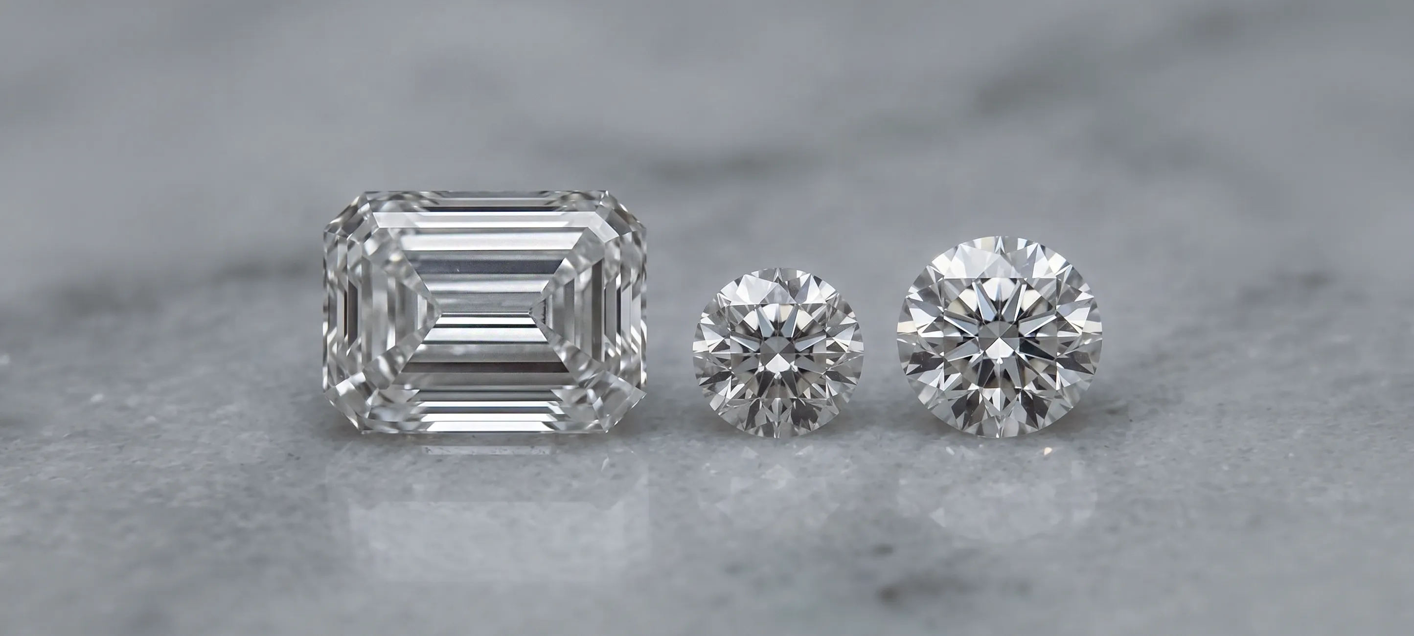 Two triangular diamonds on a black background. Click to shop lab diamonds.