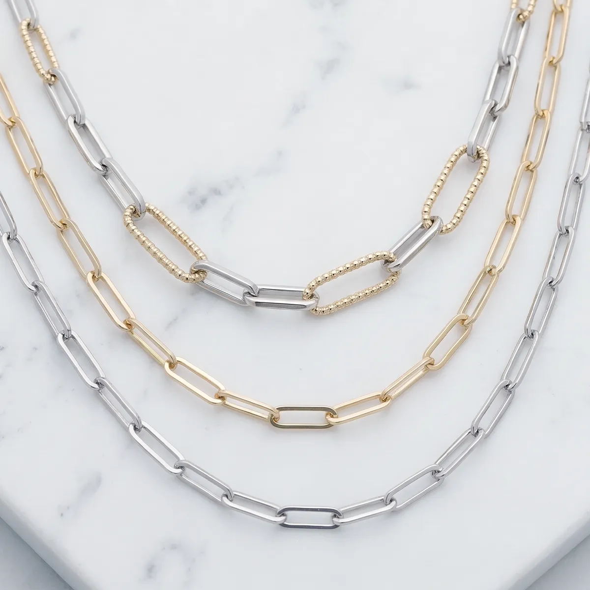 Estate chains in silver and gold on a marble surface at Georgetown Jewelers, Wood Dale, IL. Explore estate chains.
