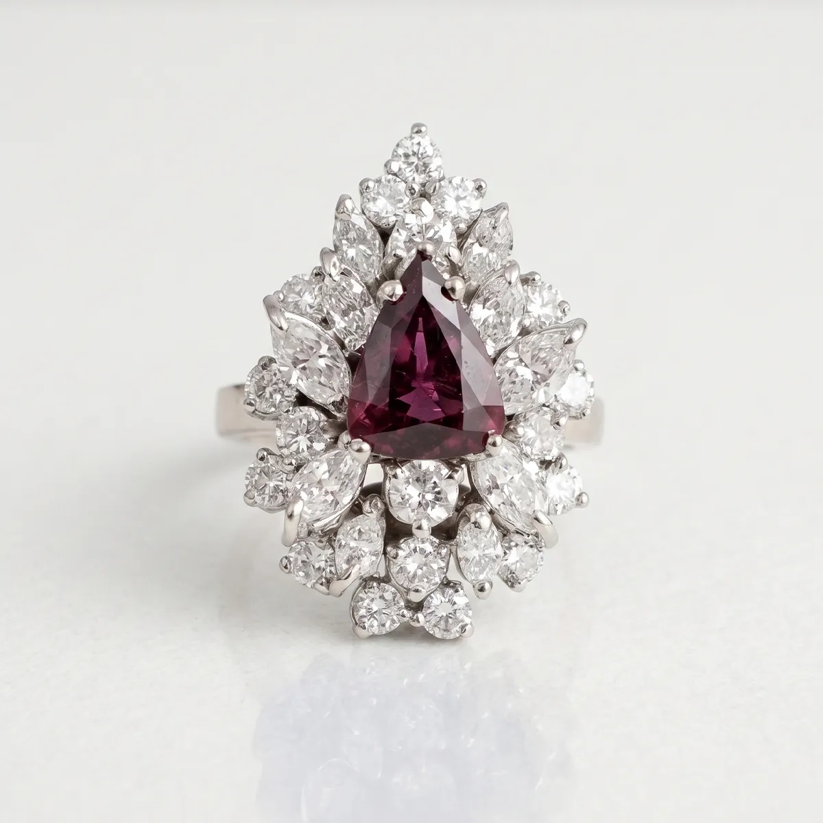 Triangular ruby ring with diamond halo at Georgetown Jewelers, Wood Dale, IL. Explore estate rings.