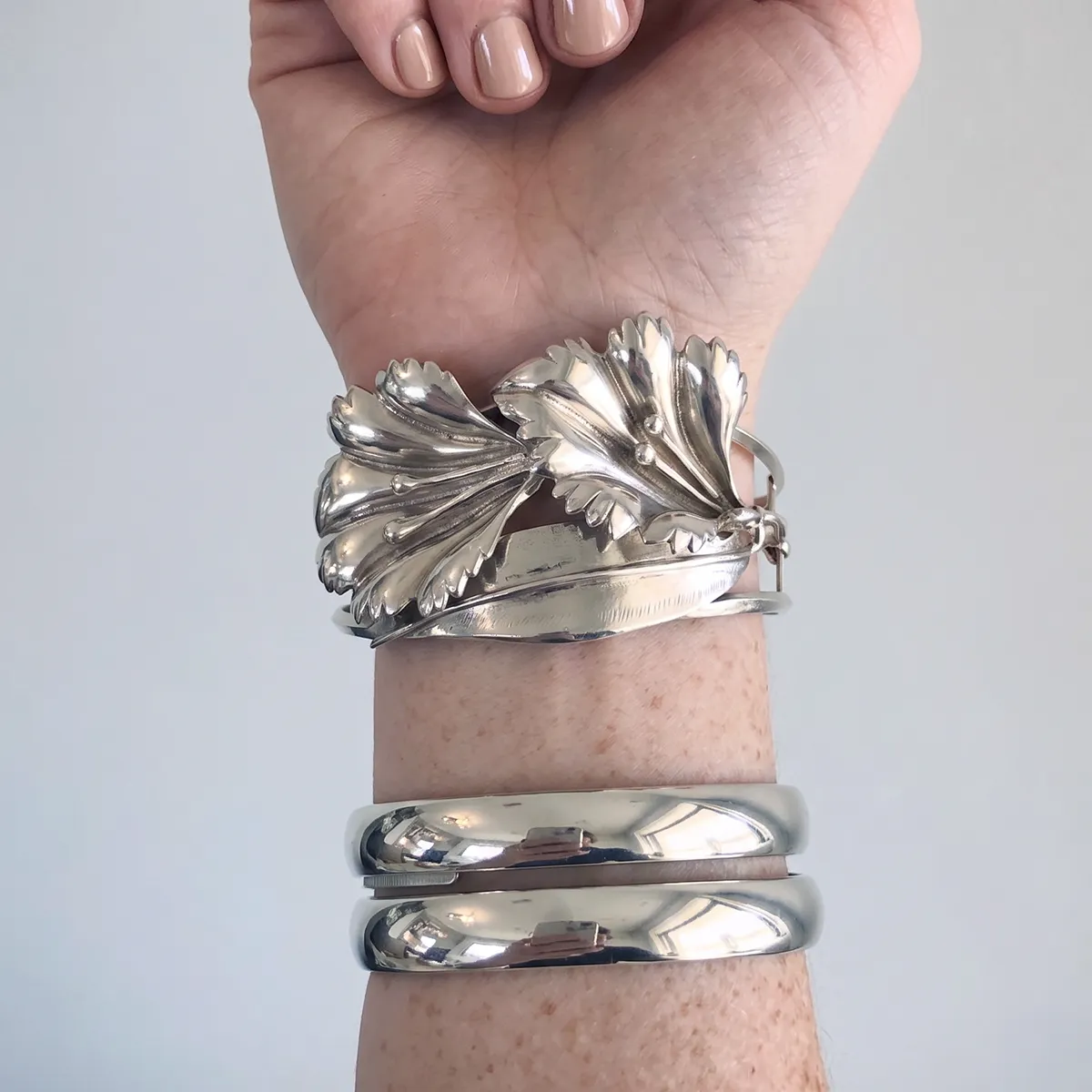 Silver estate bracelets on wrist at Georgetown Jewelers.