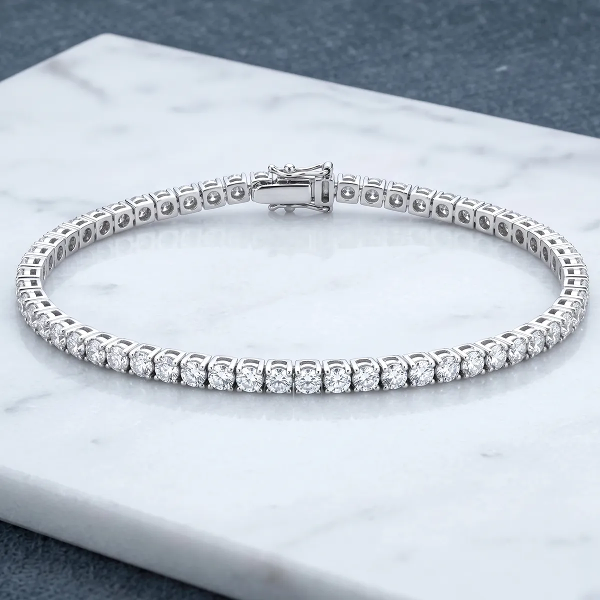 Diamond tennis bracelet on marble surface. Explore more at Georgetown Jewelers, Wood Dale, IL.
