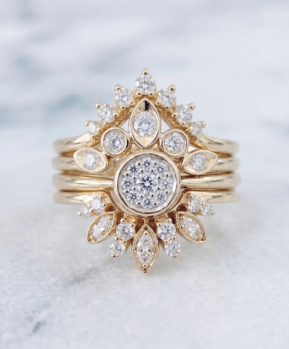 Elegant gold ring with intricate diamond cluster design on a marble surface.