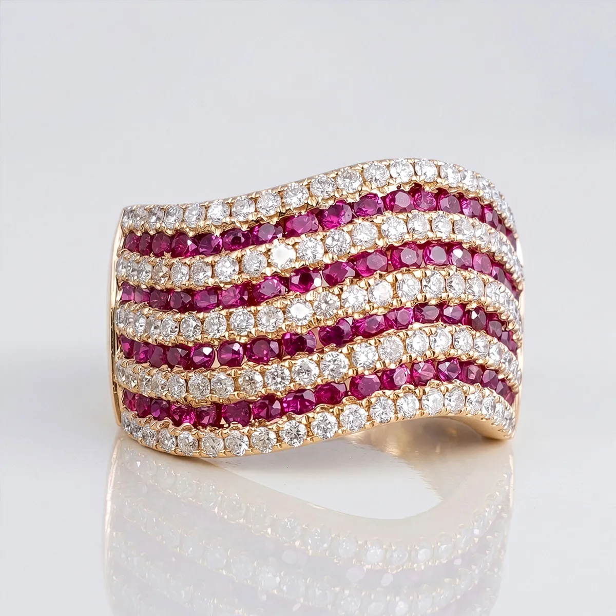 Elegant ring with alternating rows of diamonds and rubies in a wavy pattern.