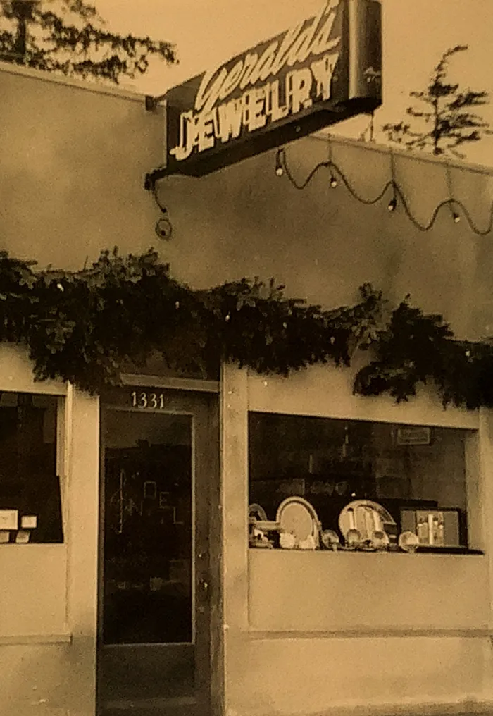 Gerald's Jewelry store sign with foliage and decorative lights.