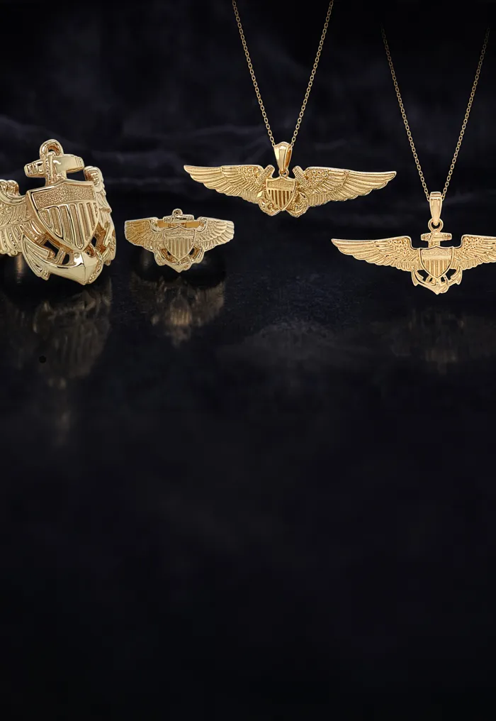 Gold military-themed jewelry including pendants and rings on a dark background.
