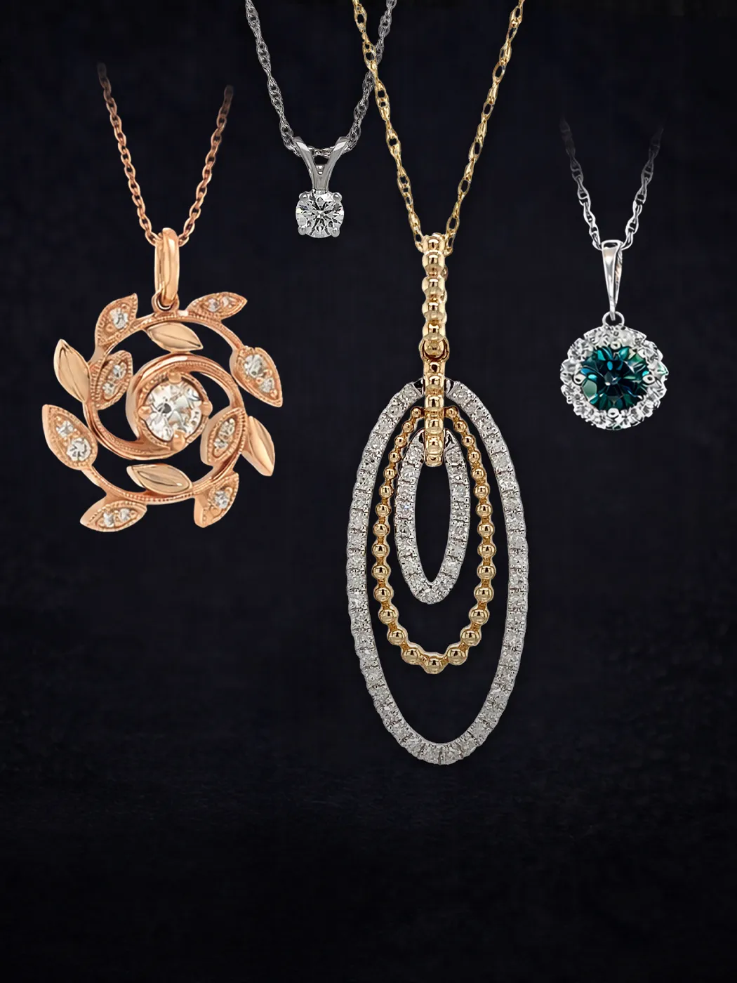 Four elegant necklaces with various pendant designs on a dark background.
