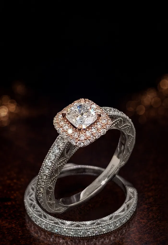 Two intricately designed rings with diamonds on a dark background.