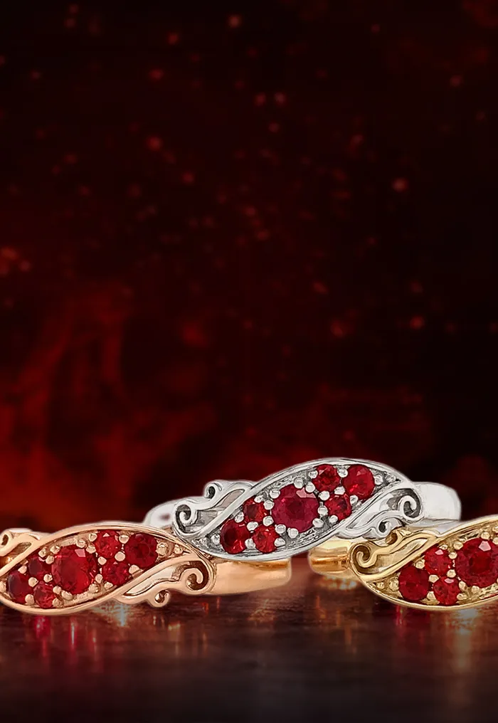 Fire ruby jewelry set against a dark background, featuring rings, earrings, and necklaces.