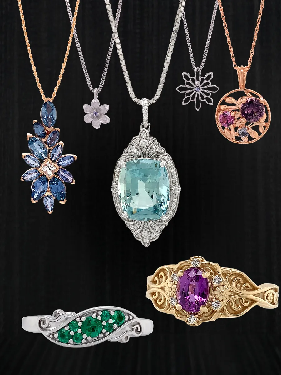 A collection of elegant gemstone necklaces and rings on a black background.