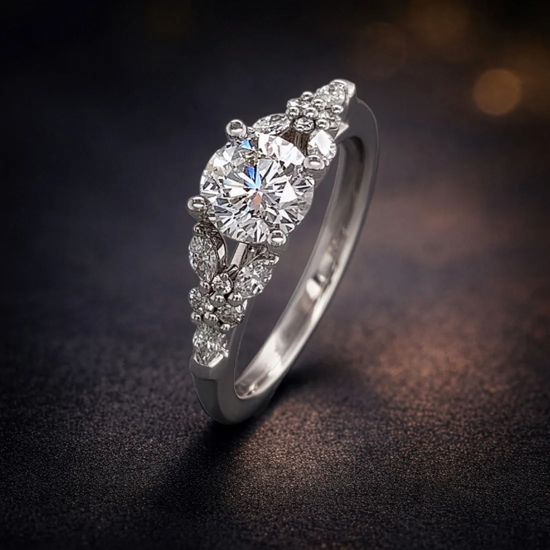 Elegant diamond ring with intricate detailing on a dark background.