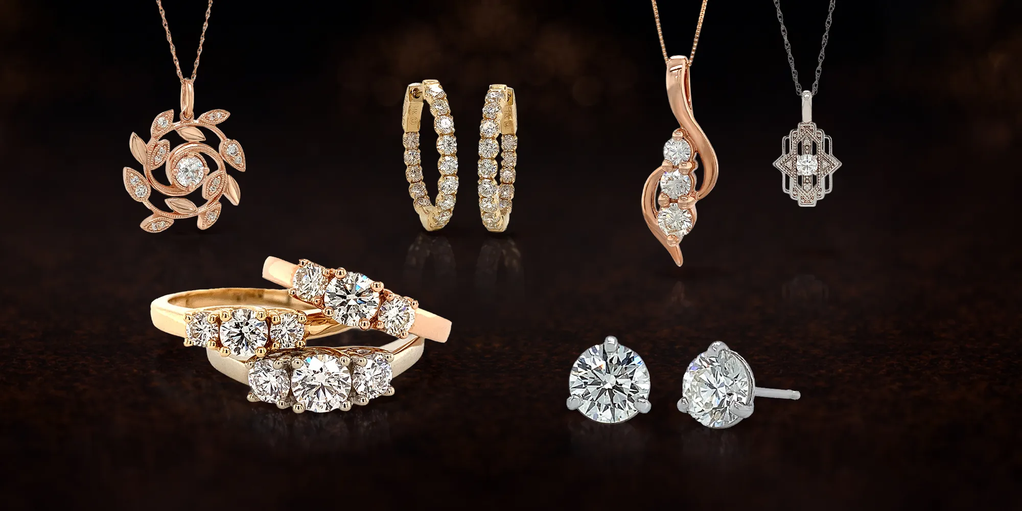 A collection of diamond jewelry including rings, earrings, and necklaces on a dark background.