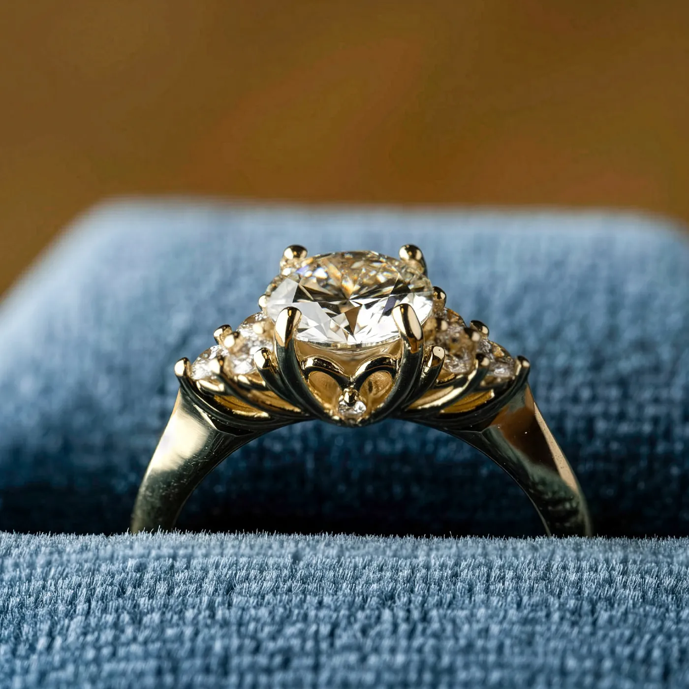 Elegant gold engagement ring with a large diamond centerpiece and smaller diamonds on the band.