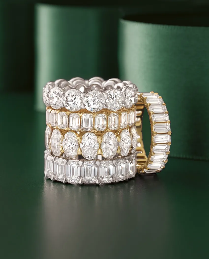 Three elegant diamond rings stacked together, showcasing various cuts and settings.