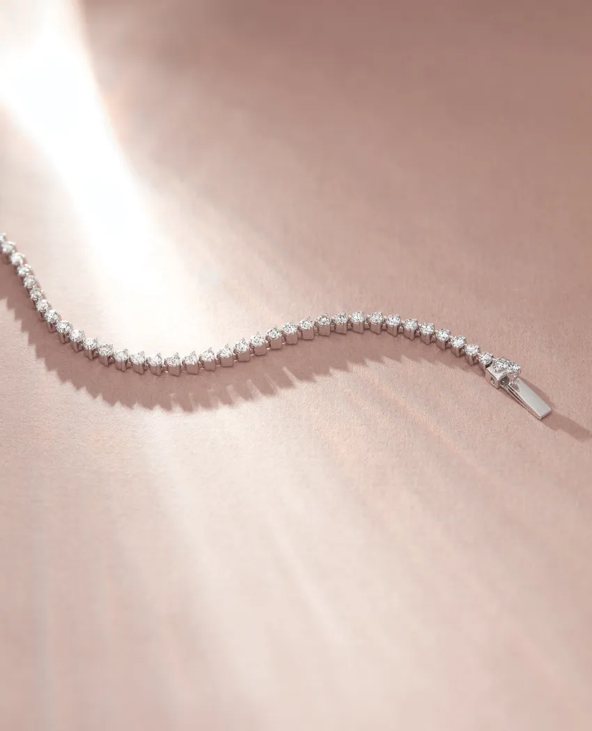 Elegant diamond bracelet on a soft surface, inviting you to explore more bracelets at Golden Gifts Jewelry.