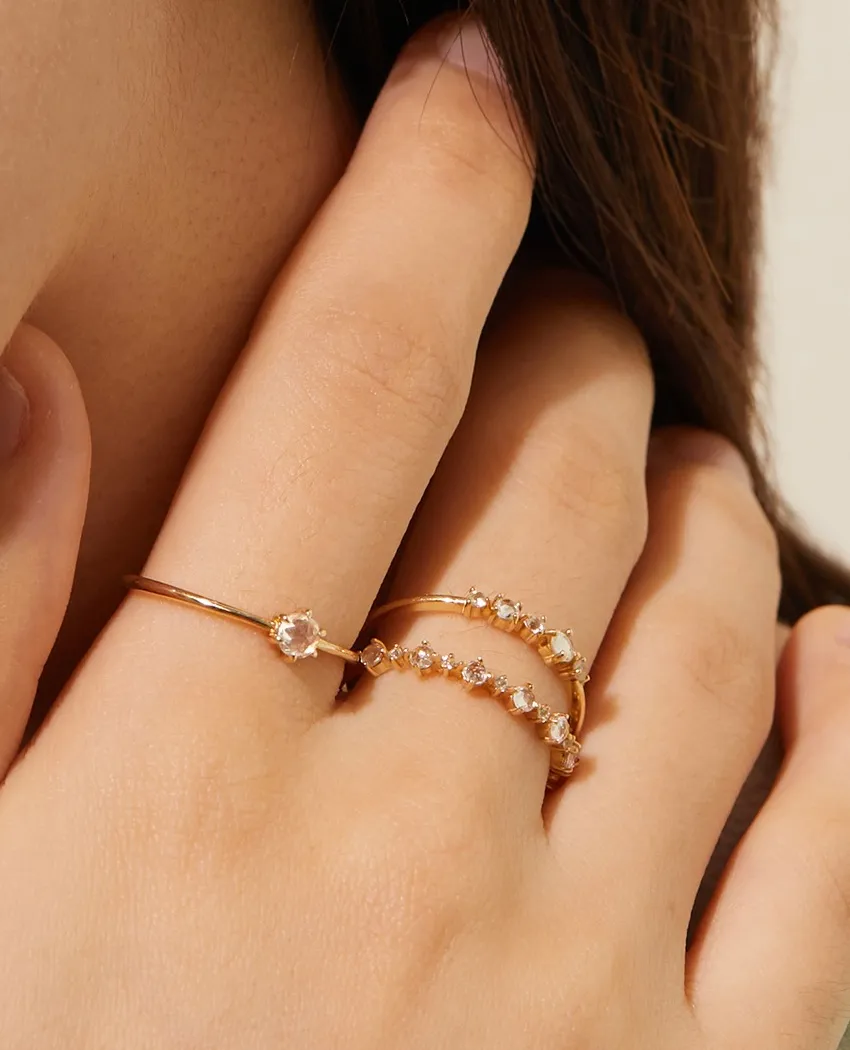 Gold rings with sparkling stones, elegantly worn on a hand. Click to explore more rings at Golden Gifts Jewelry.