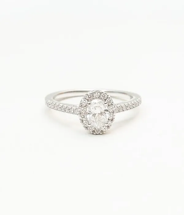 Amore This ring has an oval diamond made all the more beautiful by its halo. The side stones only further add to its classic beauty. Grader Jewelers Groton, CT