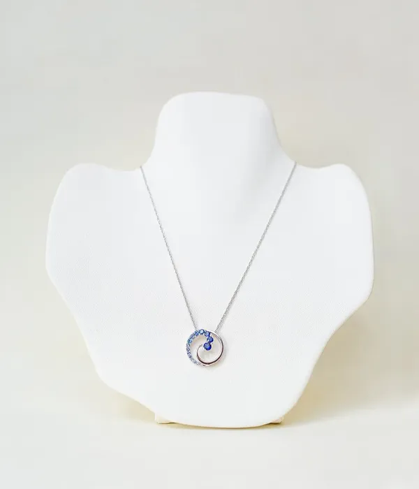  This lovely pendant is set in stunning 14-karat white gold and features a unique sapphire gradation. Grader Jewelers Groton, CT