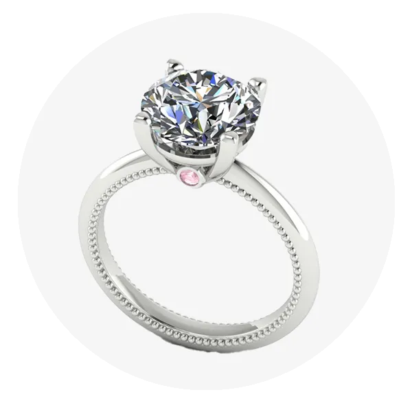 White gold round diamond solitaire engagement ring with hidden pink sapphire on band