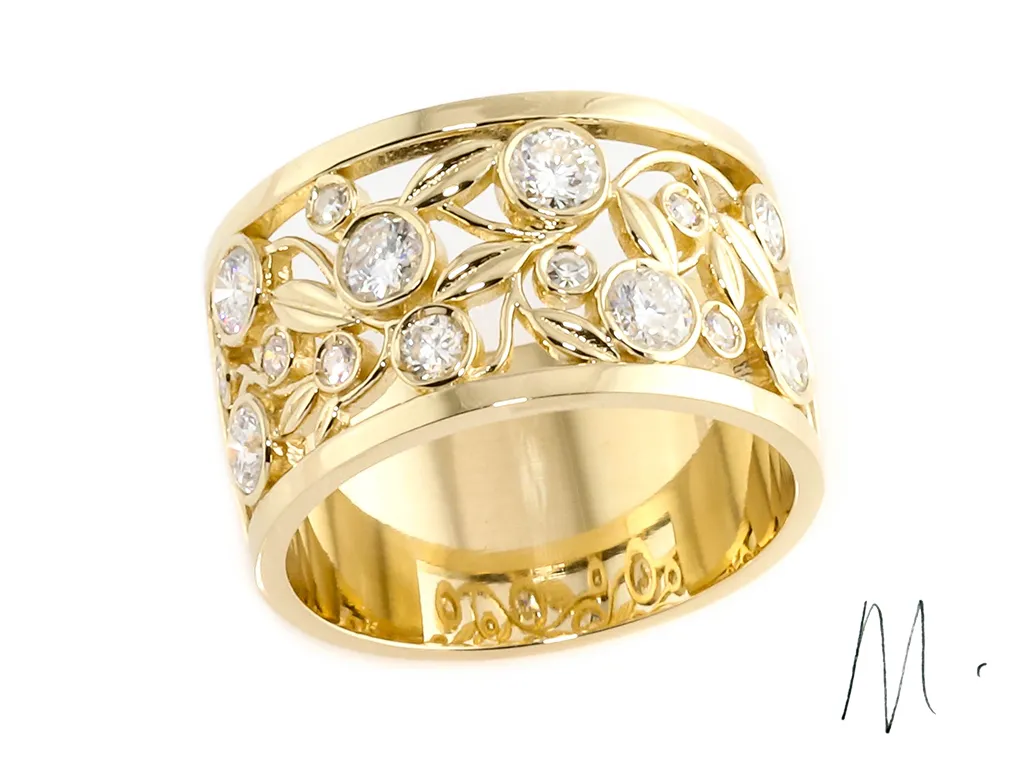 Custom designed yellow gold ring with bezel set diamonds and lef pattern