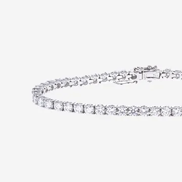 A white gold diamond tennis bracelet on grey background