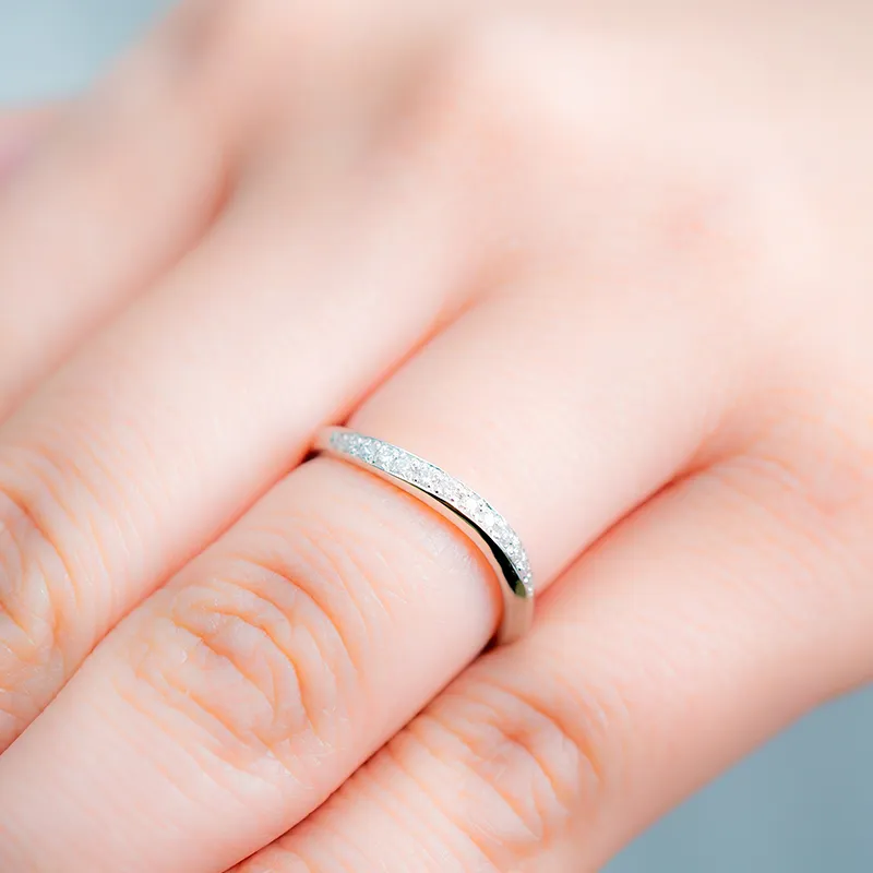 Woman wearing a white gold twisted diamond wedding band
