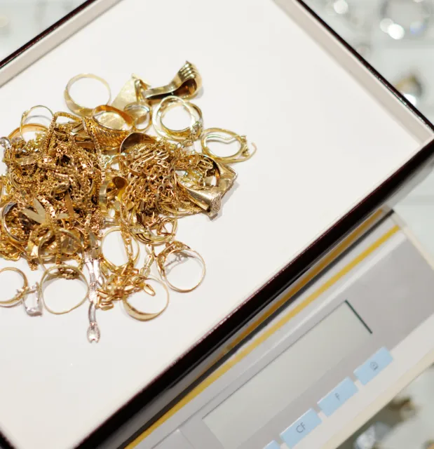Gold being weighed on a scale for trade in value in cash