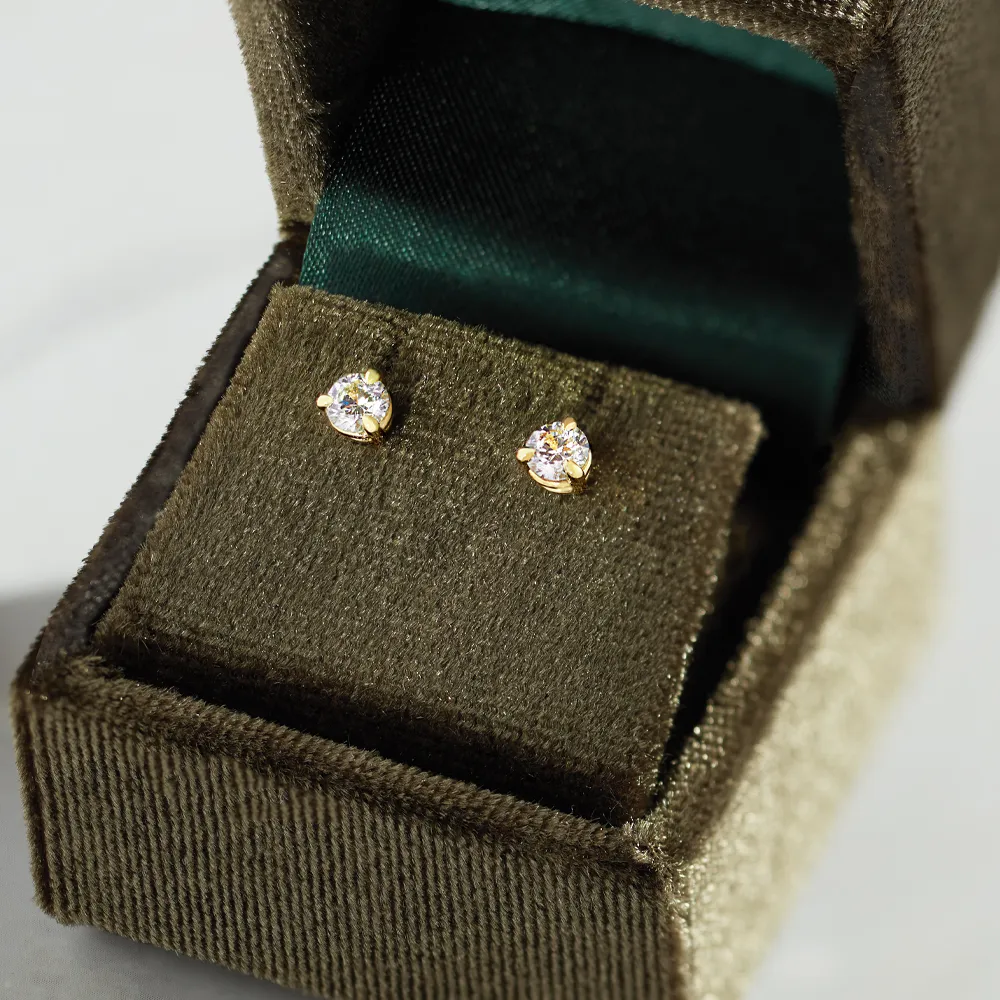 Diamond stud earrings in a velvet box from Heartland Gold, Wauchula.