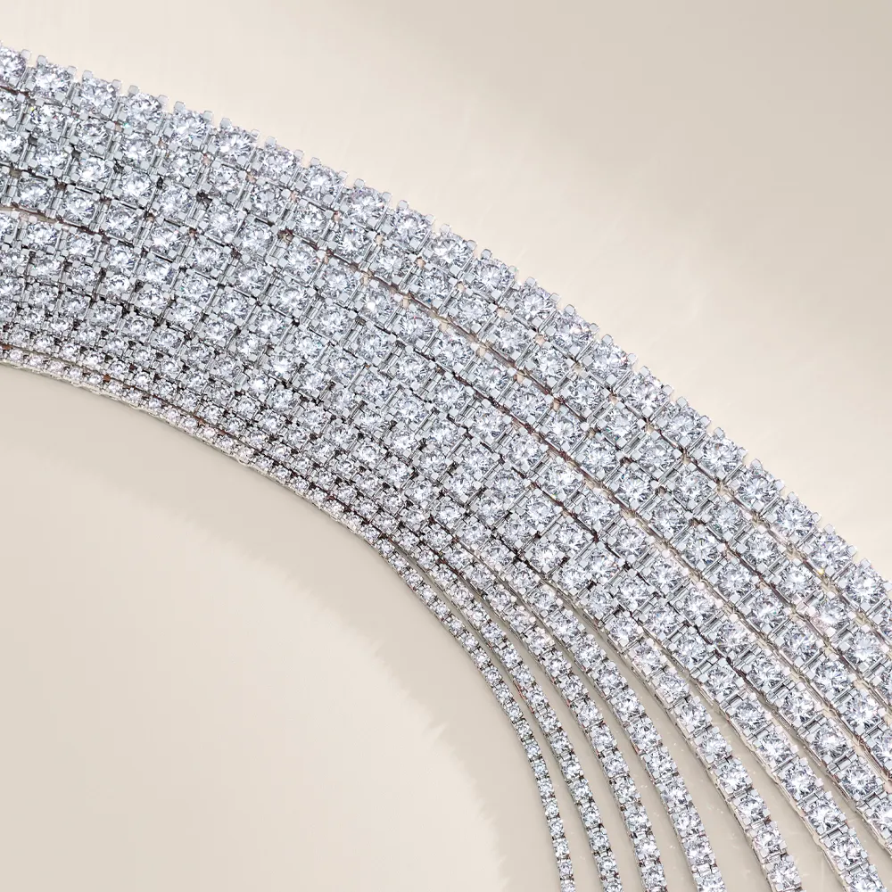 Rows of sparkling diamond tennis bracelets on a beige background.