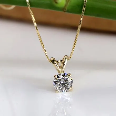 Close-up of a person wearing a diamond necklace and bracelet.