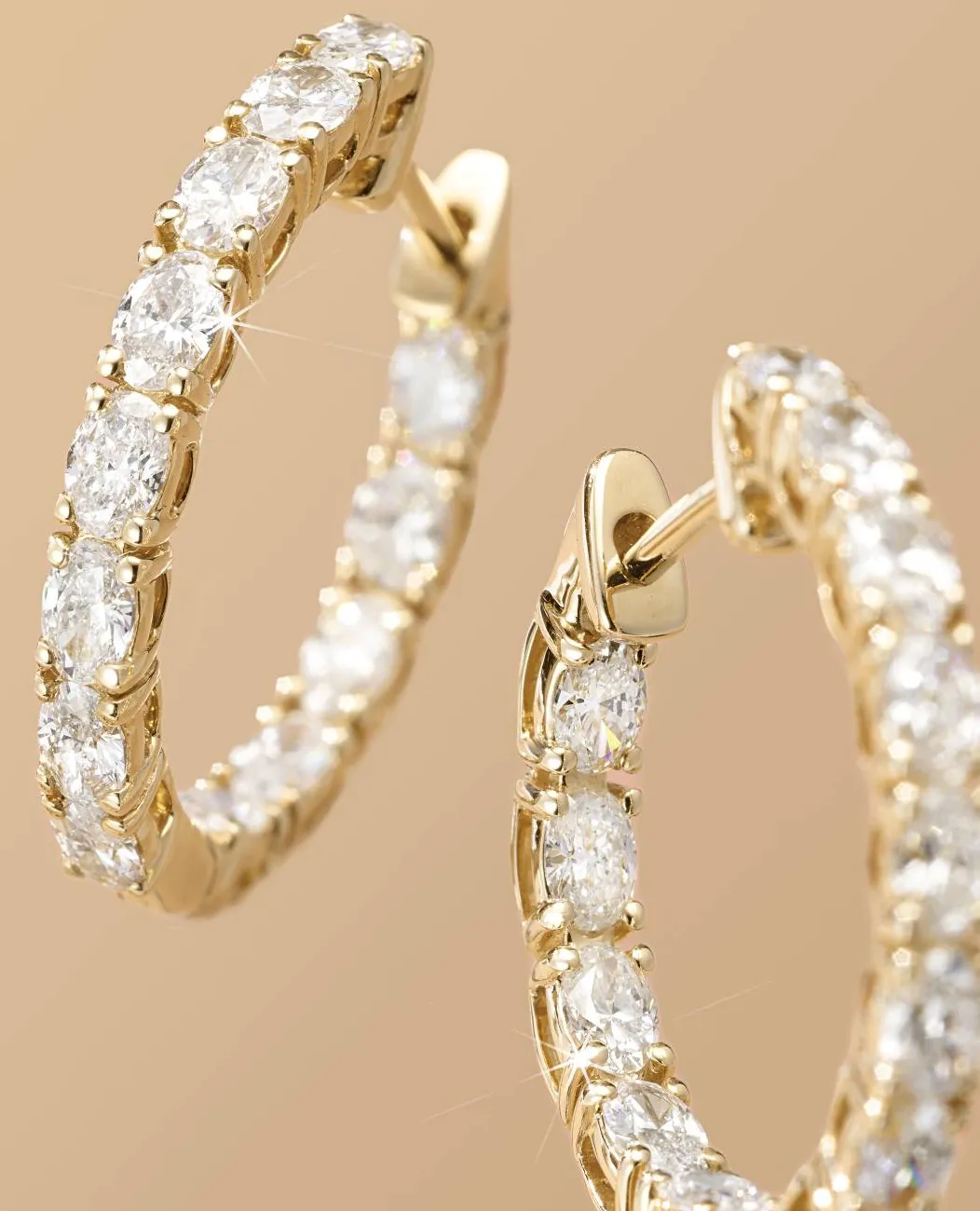 Gold hoop earrings with sparkling diamonds.