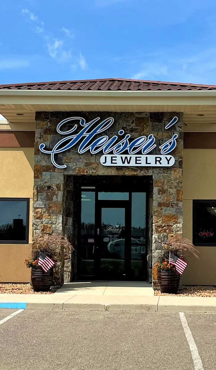 Heiser's Jewelry storefront with stone accents and signage under a blue sky.