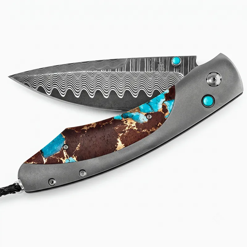 Folding knife with patterned blade and turquoise-inlaid handle.