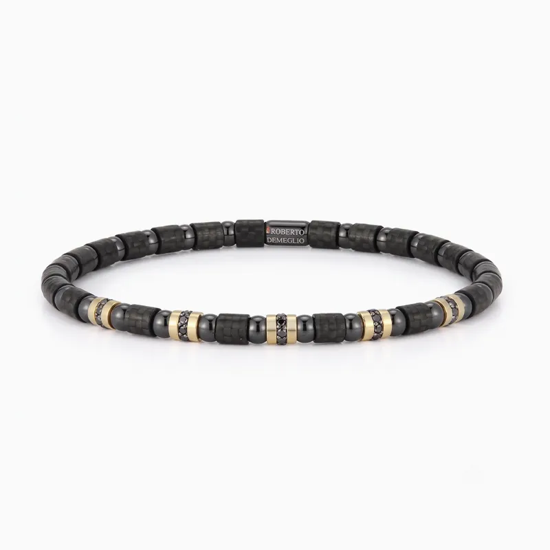 Black and gold beaded bracelet with a central logo bead on a white background.