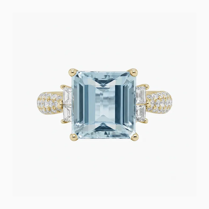 A gold ring with a large rectangular aquamarine gemstone and diamond accents.