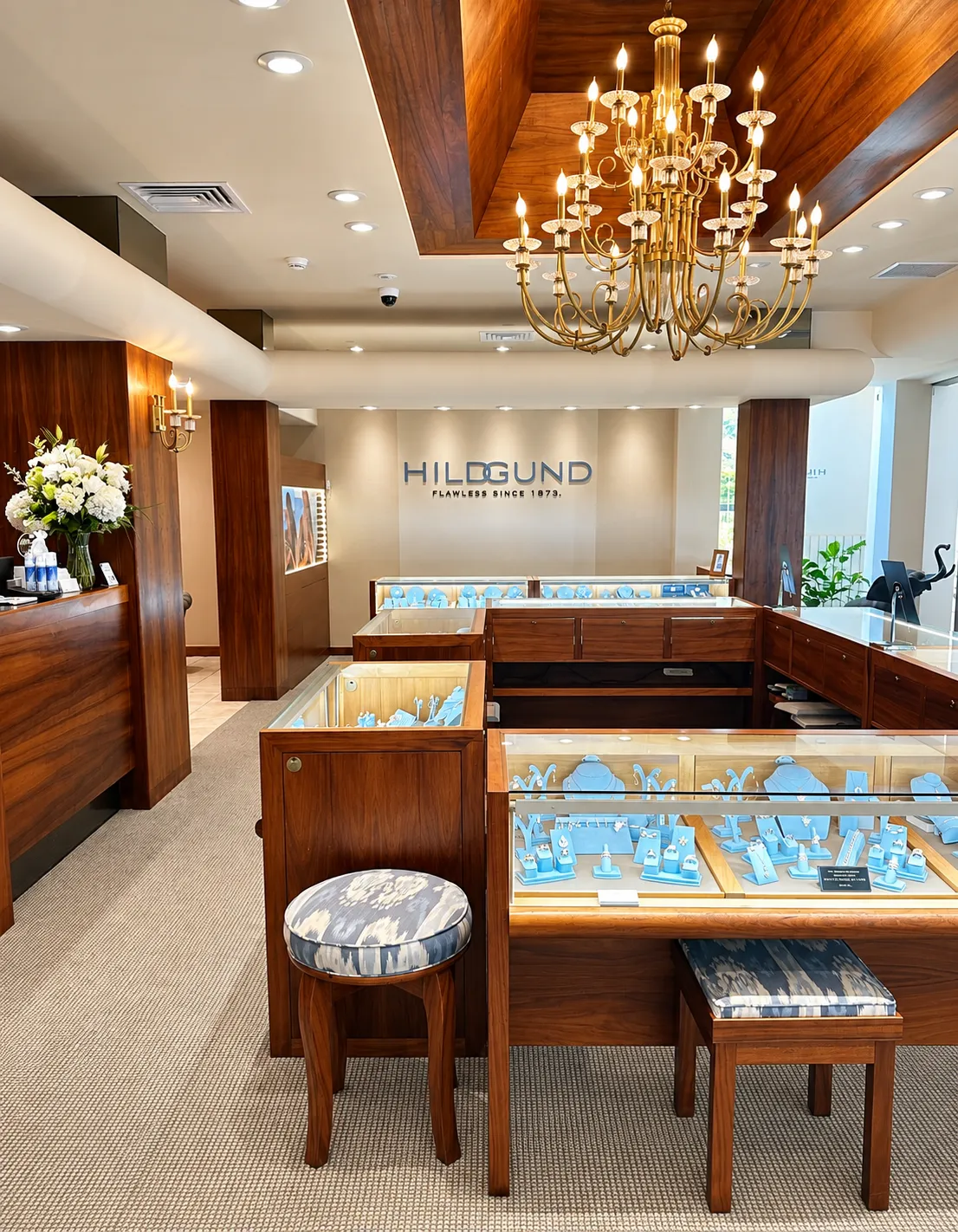 Beautiful interior of jewelry store with cases, stools and chandelier